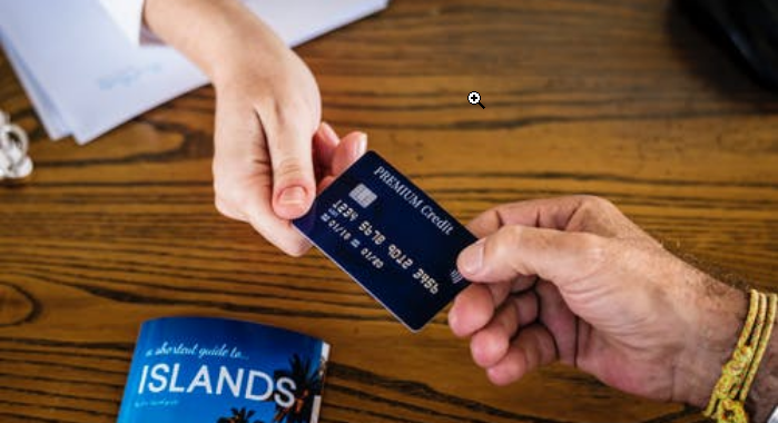 two people holding a credit card